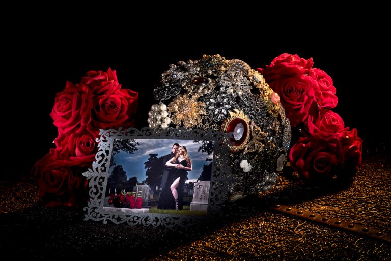 Gothic Victorian wedding invitation surrounded by red roses and decorative elements.