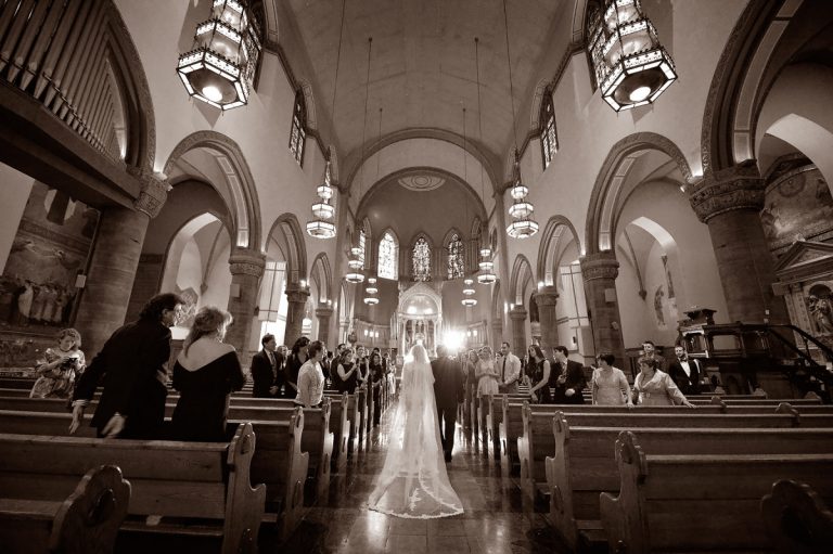 Bride and groom standing at the altar during a wedding ceremony in a church.