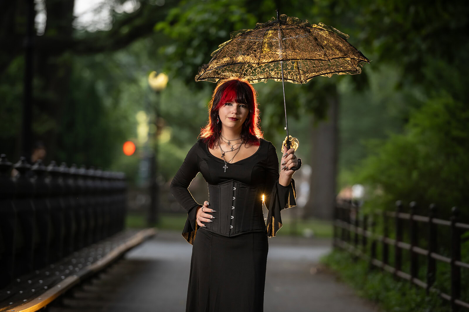 Woman with Red Hair Holding a Black Umbrella